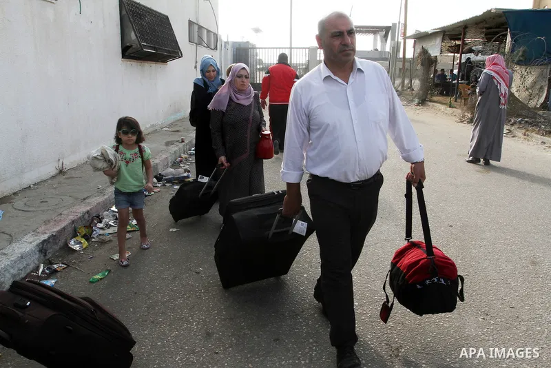 Palestinians wait for travel permits to cross into Egypt through the Rafah border crossing on October 16, 2016 in the southern Gaza Strip. Egyptian authorities temporarily reopened the crossing both directions for two da...