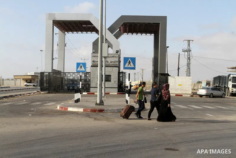 Palestinians wait for travel permits to cross into Egypt through the Rafah border crossing on October 16, 2016 in the southern Gaza Strip. Egyptian authorities temporarily reopened the crossing both directions for two da...