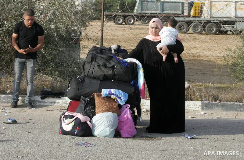 Palestinians wait for travel permits to cross into Egypt through the Rafah border crossing on October 16, 2016 in the southern Gaza Strip. Egyptian authorities temporarily reopened the crossing both directions for two da...