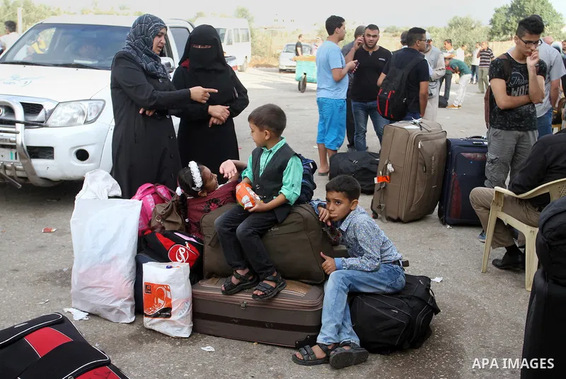 Palestinians wait for travel permits to cross into Egypt through the Rafah border crossing on October 16, 2016 in the southern Gaza Strip. Egyptian authorities temporarily reopened the crossing both directions for two da...