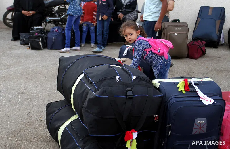 Palestinians wait for travel permits to cross into Egypt through the Rafah border crossing on October 16, 2016 in the southern Gaza Strip. Egyptian authorities temporarily reopened the crossing both directions for two da...