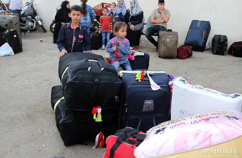 Palestinians wait for travel permits to cross into Egypt through the Rafah border crossing on October 16, 2016 in the southern Gaza Strip. Egyptian authorities temporarily reopened the crossing both directions for two da...