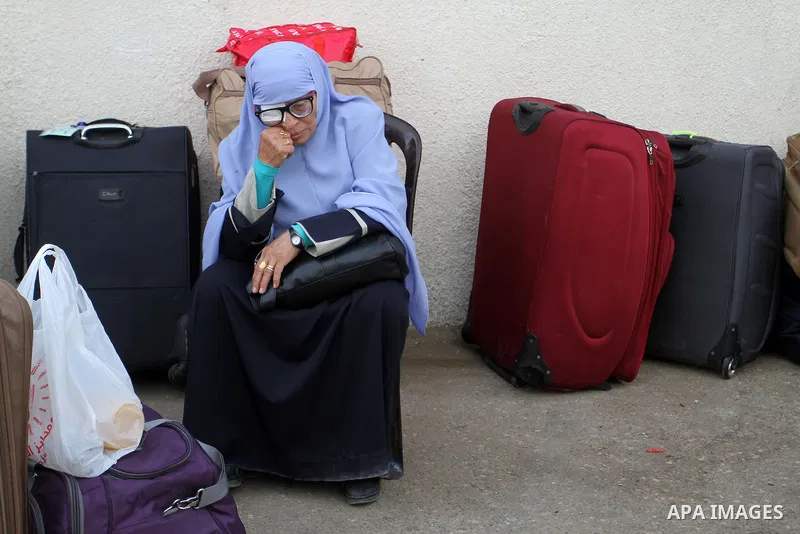 Palestinians wait for travel permits to cross into Egypt through the Rafah border crossing on October 16, 2016 in the southern Gaza Strip. Egyptian authorities temporarily reopened the crossing both directions for two da...