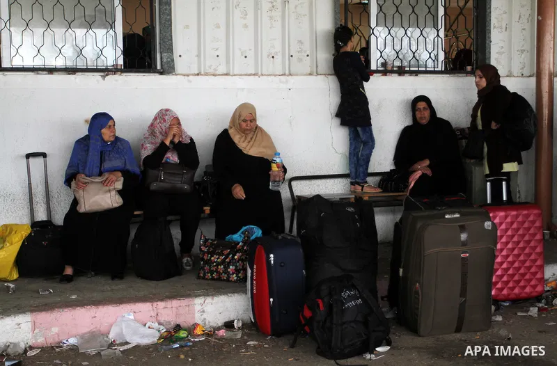 Palestinians wait for travel permits to cross into Egypt through the Rafah border crossing on October 16, 2016 in the southern Gaza Strip. Egyptian authorities temporarily reopened the crossing both directions for two da...