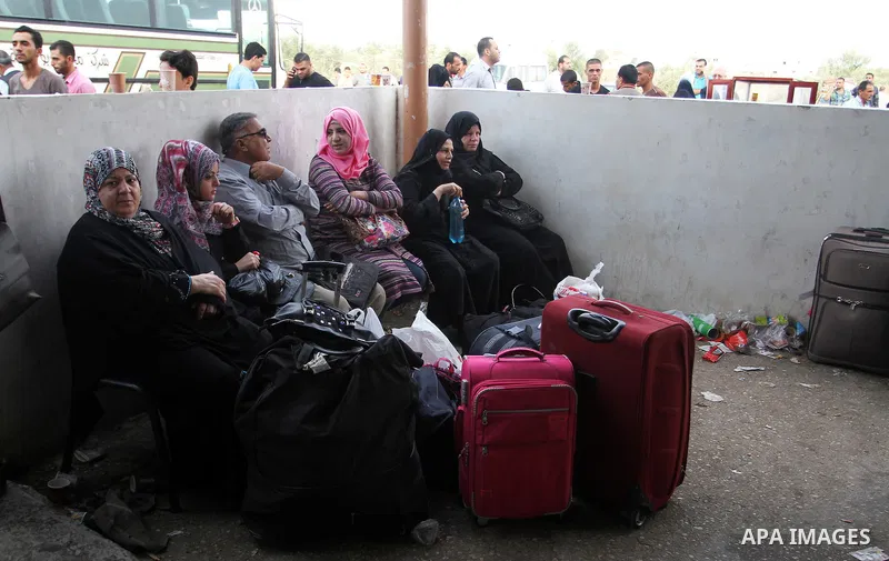Palestinians wait for travel permits to cross into Egypt through the Rafah border crossing on October 16, 2016 in the southern Gaza Strip. Egyptian authorities temporarily reopened the crossing both directions for two da...