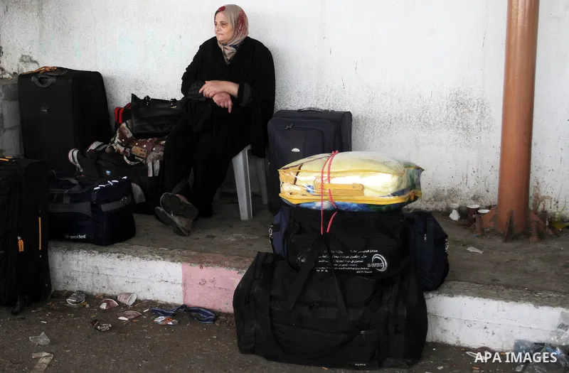 Palestinians wait for travel permits to cross into Egypt through the Rafah border crossing on October 16, 2016 in the southern Gaza Strip. Egyptian authorities temporarily reopened the crossing both directions for two da...