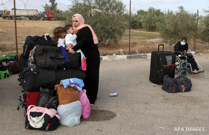 Palestinians wait for travel permits to cross into Egypt through the Rafah border crossing on October 16, 2016 in the southern Gaza Strip. Egyptian authorities temporarily reopened the crossing both directions for two da...