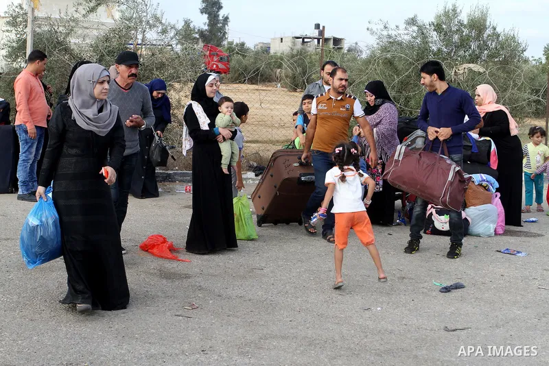Palestinians wait for travel permits to cross into Egypt through the Rafah border crossing on October 16, 2016 in the southern Gaza Strip. Egyptian authorities temporarily reopened the crossing both directions for two da...
