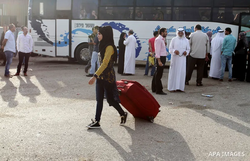 Palestinians wait for travel permits to cross into Egypt through the Rafah border crossing on October 16, 2016 in the southern Gaza Strip. Egyptian authorities temporarily reopened the crossing both directions for two da...
