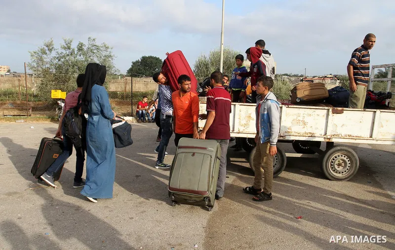 Palestinians wait for travel permits to cross into Egypt through the Rafah border crossing on October 16, 2016 in the southern Gaza Strip. Egyptian authorities temporarily reopened the crossing both directions for two da...