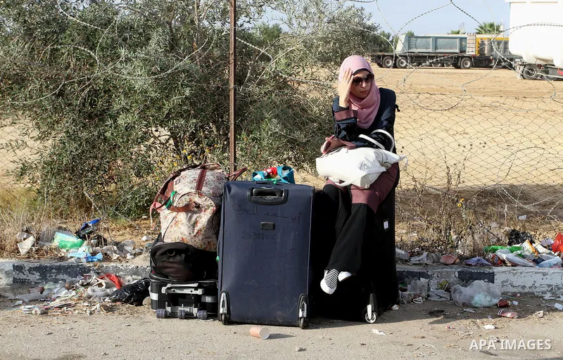 Palestinians wait for travel permits to cross into Egypt through the Rafah border crossing on October 16, 2016 in the southern Gaza Strip. Egyptian authorities temporarily reopened the crossing both directions for two da...