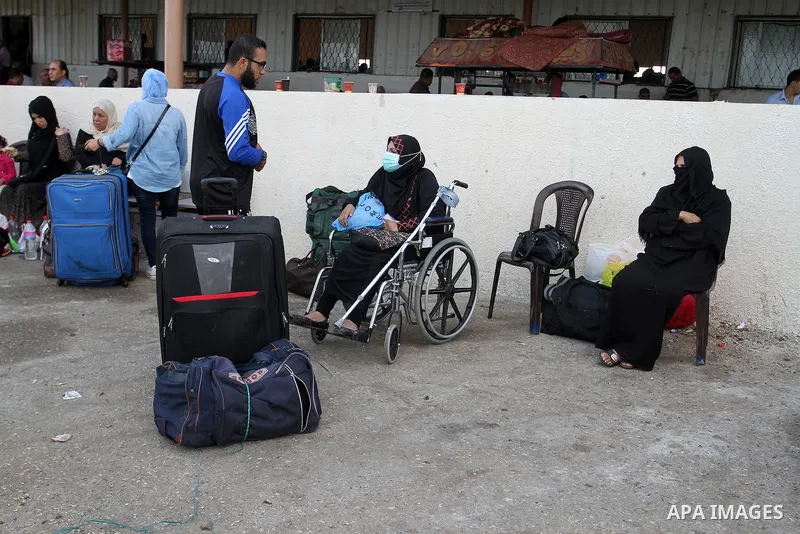 Palestinians wait for travel permits to cross into Egypt through the Rafah border crossing on October 16, 2016 in the southern Gaza Strip. Egyptian authorities temporarily reopened the crossing both directions for two da...
