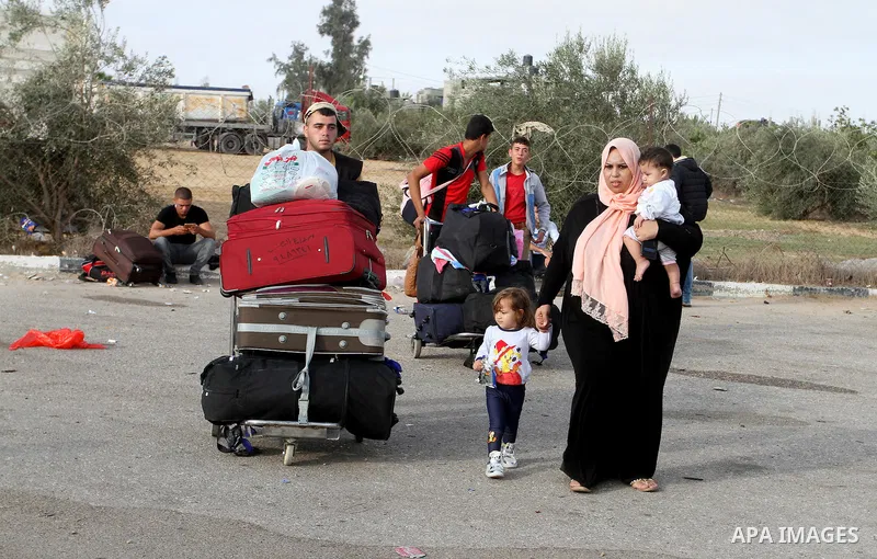 Palestinians wait for travel permits to cross into Egypt through the Rafah border crossing on October 16, 2016 in the southern Gaza Strip. Egyptian authorities temporarily reopened the crossing both directions for two da...