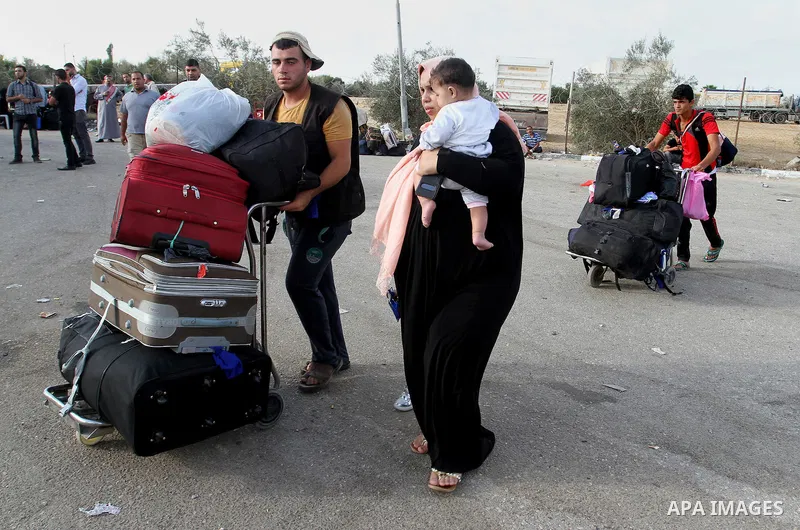 Palestinians wait for travel permits to cross into Egypt through the Rafah border crossing on October 16, 2016 in the southern Gaza Strip. Egyptian authorities temporarily reopened the crossing both directions for two da...