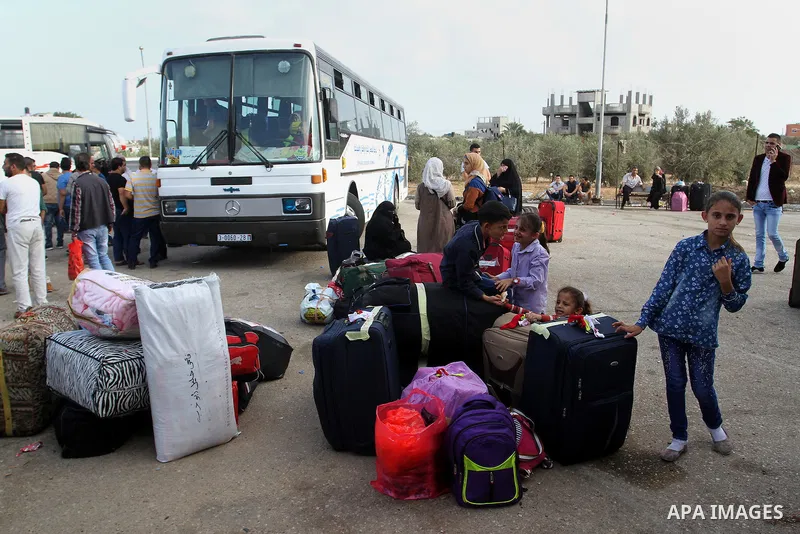 Palestinians wait for travel permits to cross into Egypt through the Rafah border crossing on October 16, 2016 in the southern Gaza Strip. Egyptian authorities temporarily reopened the crossing both directions for two da...
