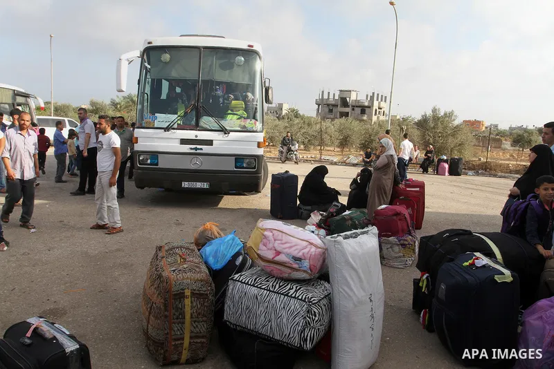 Palestinians wait for travel permits to cross into Egypt through the Rafah border crossing on October 16, 2016 in the southern Gaza Strip. Egyptian authorities temporarily reopened the crossing both directions for two da...