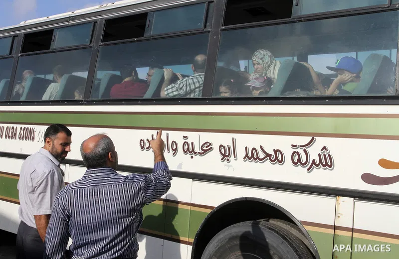 Palestinians wait for travel permits to cross into Egypt through the Rafah border crossing on October 16, 2016 in the southern Gaza Strip. Egyptian authorities temporarily reopened the crossing both directions for two da...