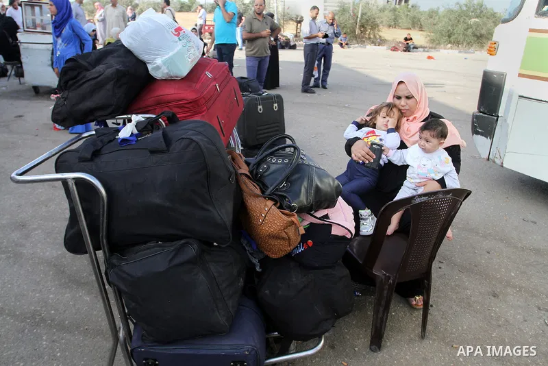 Palestinians wait for travel permits to cross into Egypt through the Rafah border crossing on October 16, 2016 in the southern Gaza Strip. Egyptian authorities temporarily reopened the crossing both directions for two da...