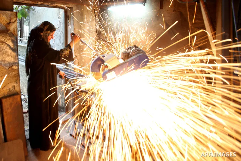 A Palestinian woman Ranim Safadi, 30-year-old, works at the metal workshop in the West bank village of Urif, near Nablus, on Oct. 18, 2016. Safadi is the first woman in the West bank works at the field of blacksmithing w...