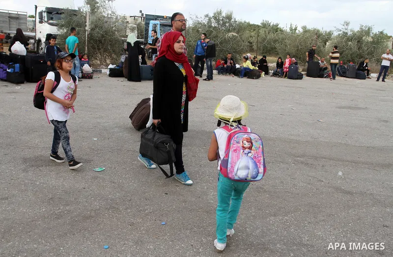 Palestinians wait for travel permits to cross into Egypt through the Rafah border crossing after it was opened by Egyptian authorities for humanitarian cases, in Rafah in the southern Gaza Strip October 19, 2016. Photo b...