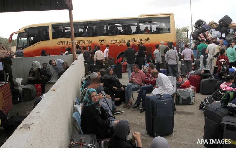 Palestinians wait for travel permits to cross into Egypt through the Rafah border crossing after it was opened by Egyptian authorities for humanitarian cases, in Rafah in the southern Gaza Strip October 19, 2016. Photo b...