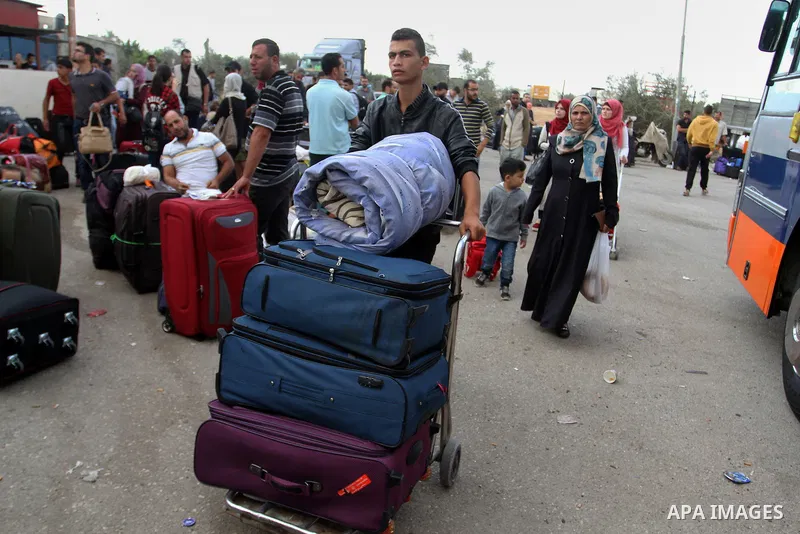 Palestinians wait for travel permits to cross into Egypt through the Rafah border crossing after it was opened by Egyptian authorities for humanitarian cases, in Rafah in the southern Gaza Strip October 19, 2016. Photo b...