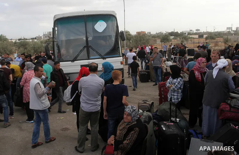 Palestinians wait for travel permits to cross into Egypt through the Rafah border crossing after it was opened by Egyptian authorities for humanitarian cases, in Rafah in the southern Gaza Strip October 19, 2016. Photo b...
