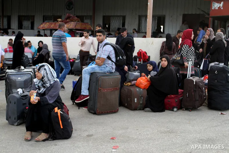 Palestinians wait for travel permits to cross into Egypt through the Rafah border crossing after it was opened by Egyptian authorities for humanitarian cases, in Rafah in the southern Gaza Strip October 19, 2016. Photo b...