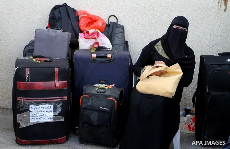 Palestinians wait for travel permits to cross into Egypt through the Rafah border crossing after it was opened by Egyptian authorities for humanitarian cases, in Rafah in the southern Gaza Strip October 19, 2016. Photo b...