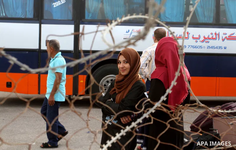 Palestinians wait for travel permits to cross into Egypt through the Rafah border crossing after it was opened by Egyptian authorities for humanitarian cases, in Rafah in the southern Gaza Strip October 19, 2016. Photo b...