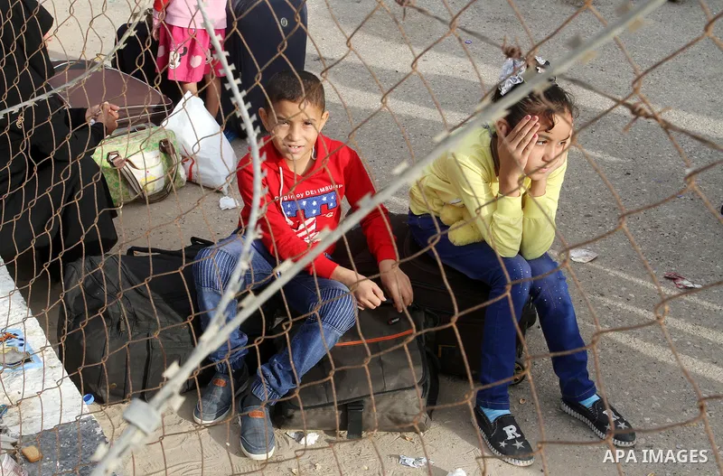 Palestinians wait for travel permits to cross into Egypt through the Rafah border crossing after it was opened by Egyptian authorities for humanitarian cases, in Rafah in the southern Gaza Strip October 19, 2016. Photo b...
