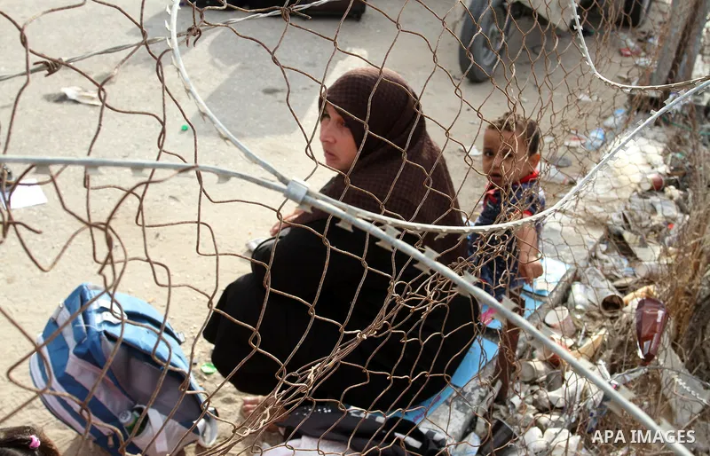 Palestinians wait for travel permits to cross into Egypt through the Rafah border crossing after it was opened by Egyptian authorities for humanitarian cases, in Rafah in the southern Gaza Strip October 19, 2016. Photo b...