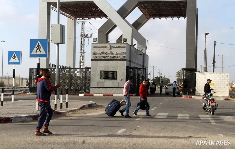 Palestinians wait for travel permits to cross into Egypt through the Rafah border crossing after it was opened by Egyptian authorities for humanitarian cases, in Rafah in the southern Gaza Strip October 19, 2016. Photo b...