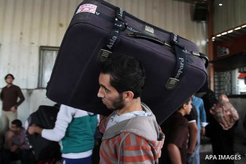 Palestinians wait for travel permits to cross into Egypt through the Rafah border crossing after it was opened by Egyptian authorities for humanitarian cases, in Rafah in the southern Gaza Strip October 19, 2016. Photo b...
