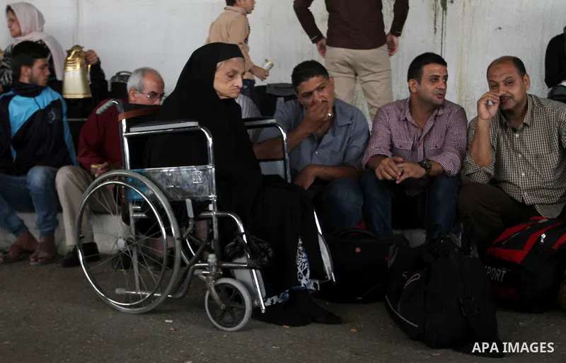 Palestinians wait for travel permits to cross into Egypt through the Rafah border crossing after it was opened by Egyptian authorities for humanitarian cases, in Rafah in the southern Gaza Strip October 19, 2016. Photo b...