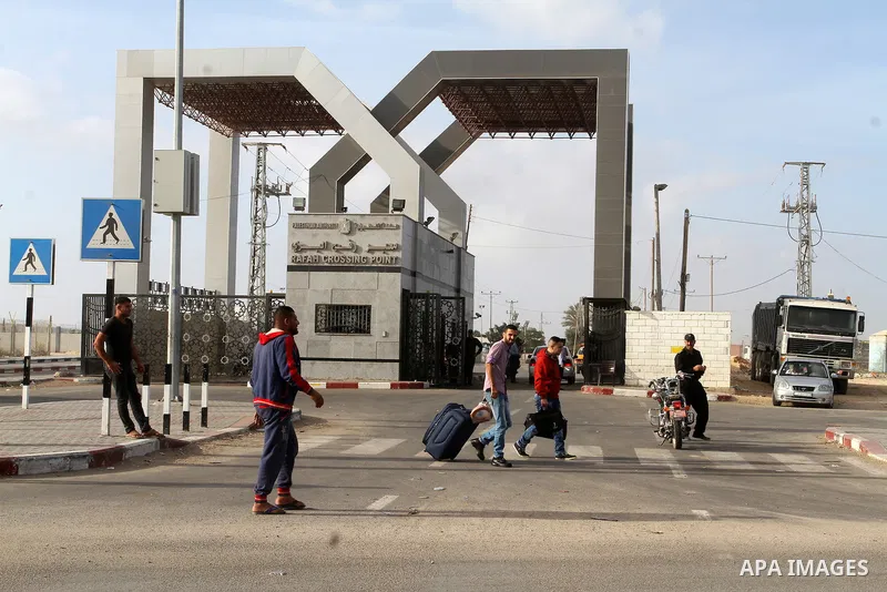 Palestinians wait for travel permits to cross into Egypt through the Rafah border crossing after it was opened by Egyptian authorities for humanitarian cases, in Rafah in the southern Gaza Strip October 19, 2016. Photo b...
