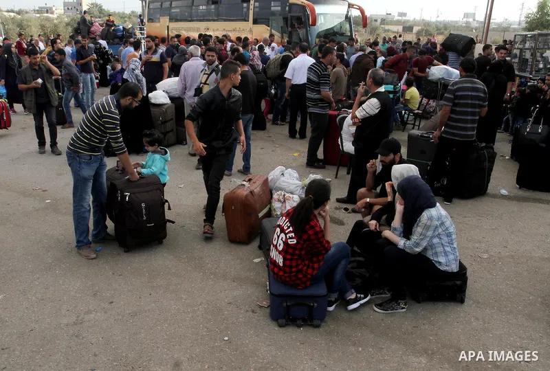 Palestinians wait for travel permits to cross into Egypt through the Rafah border crossing after it was opened by Egyptian authorities for humanitarian cases, in Rafah in the southern Gaza Strip October 19, 2016. Photo b...