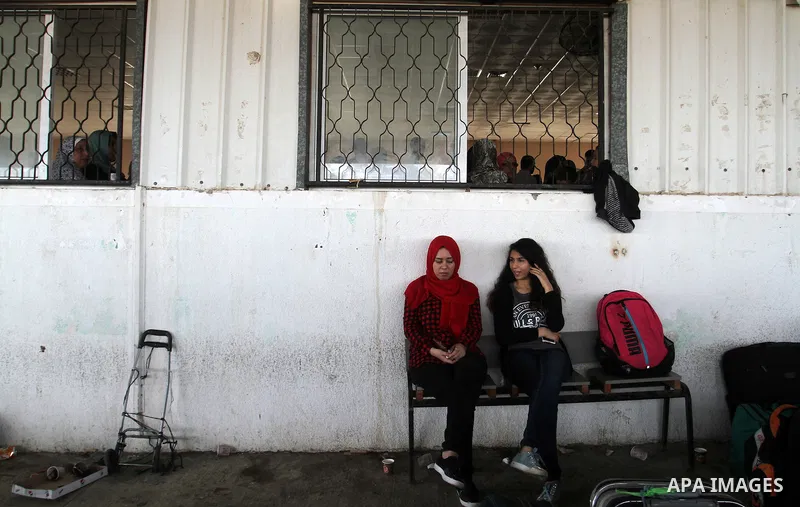 Palestinians wait for travel permits to cross into Egypt through the Rafah border crossing after it was opened by Egyptian authorities for humanitarian cases, in Rafah in the southern Gaza Strip October 19, 2016. Photo b...