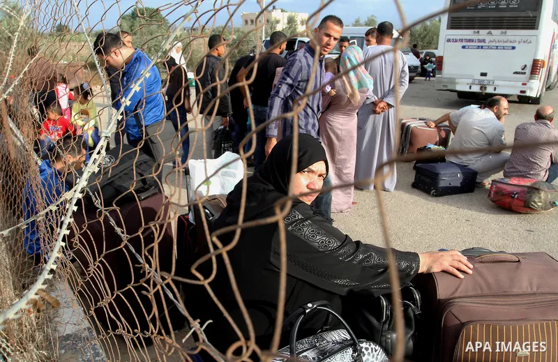 Palestinians wait for travel permits to cross into Egypt through the Rafah border crossing after it was opened by Egyptian authorities for humanitarian cases, in Rafah in the southern Gaza Strip October 19, 2016. Photo b...