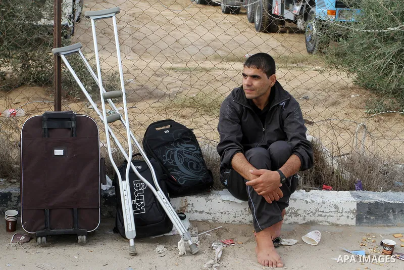 Palestinians wait for travel permits to cross into Egypt through the Rafah border crossing after it was opened by Egyptian authorities for humanitarian cases, in Rafah in the southern Gaza Strip October 19, 2016. Photo b...