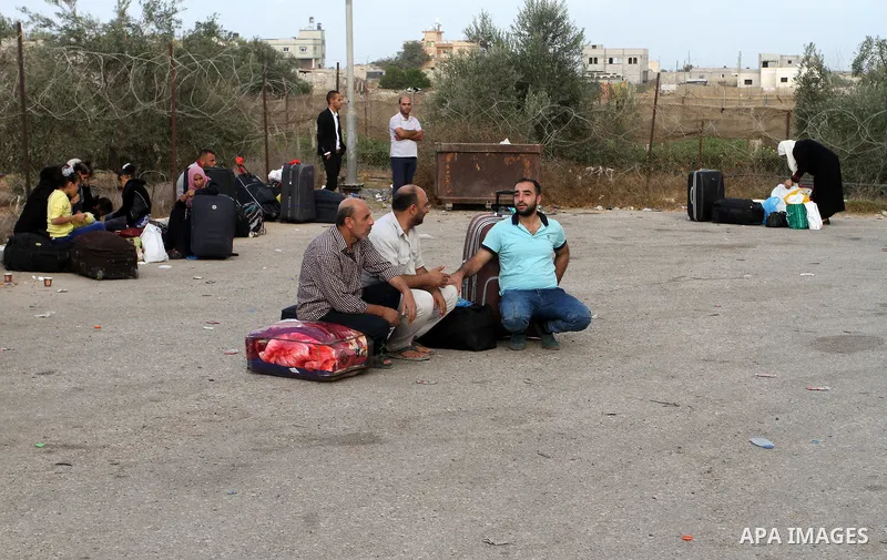 Palestinians wait for travel permits to cross into Egypt through the Rafah border crossing after it was opened by Egyptian authorities for humanitarian cases, in Rafah in the southern Gaza Strip October 19, 2016. Photo b...