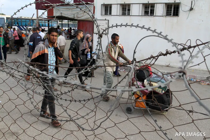 Palestinians wait for travel permits to cross into Egypt through the Rafah border crossing after it was opened by Egyptian authorities for humanitarian cases, in Rafah in the southern Gaza Strip October 19, 2016. Photo b...