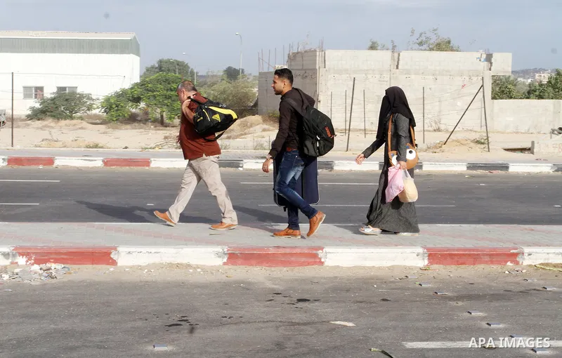 Palestinians wait for travel permits to cross into Egypt through the Rafah border crossing after it was opened by Egyptian authorities for humanitarian cases, in Rafah in the southern Gaza Strip October 19, 2016. Photo b...