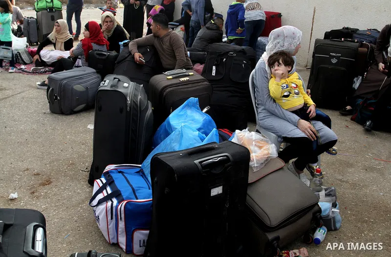 Palestinians wait for travel permits to cross into Egypt through the Rafah border crossing after it was opened by Egyptian authorities for humanitarian cases, in Rafah in the southern Gaza Strip October 19, 2016. Photo b...