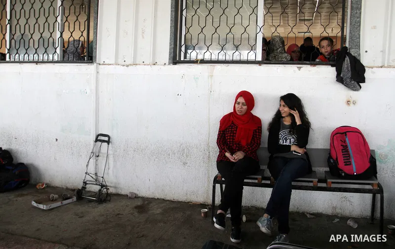 Palestinians wait for travel permits to cross into Egypt through the Rafah border crossing after it was opened by Egyptian authorities for humanitarian cases, in Rafah in the southern Gaza Strip October 19, 2016. Photo b...