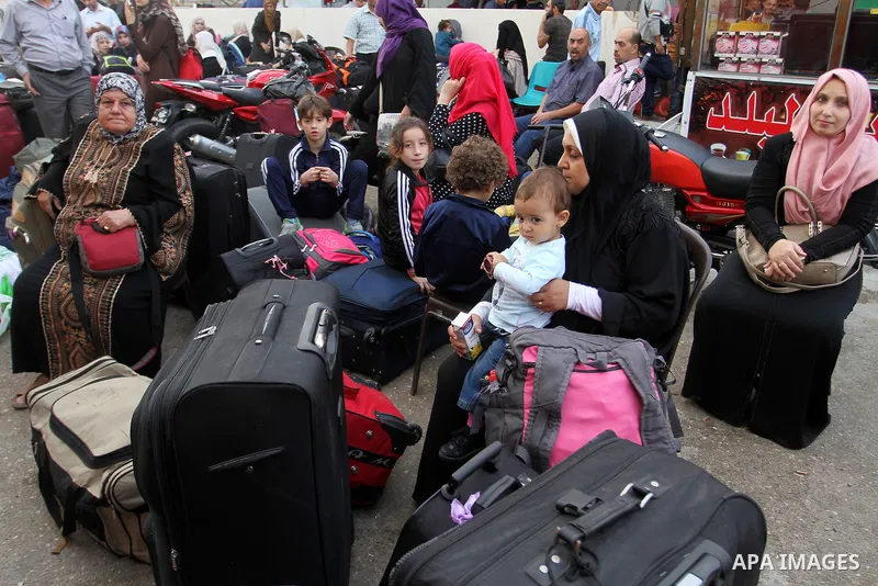 Palestinians wait for travel permits to cross into Egypt through the Rafah border crossing after it was opened by Egyptian authorities for humanitarian cases, in Rafah in the southern Gaza Strip October 19, 2016. Photo b...