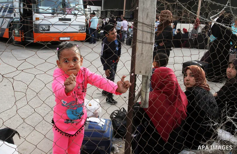 Palestinians wait for travel permits to cross into Egypt through the Rafah border crossing after it was opened by Egyptian authorities for humanitarian cases, in Rafah in the southern Gaza Strip October 19, 2016. Photo b...
