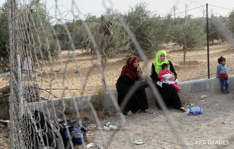 Palestinians wait for travel permits to cross into Egypt through the Rafah border crossing after it was opened by Egyptian authorities for humanitarian cases, in Rafah in the southern Gaza Strip October 19, 2016. Photo b...