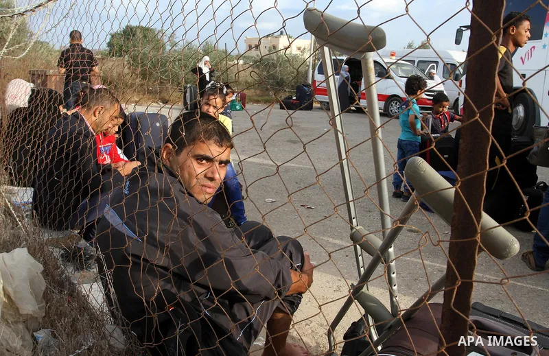 Palestinians wait for travel permits to cross into Egypt through the Rafah border crossing after it was opened by Egyptian authorities for humanitarian cases, in Rafah in the southern Gaza Strip October 19, 2016. Photo b...