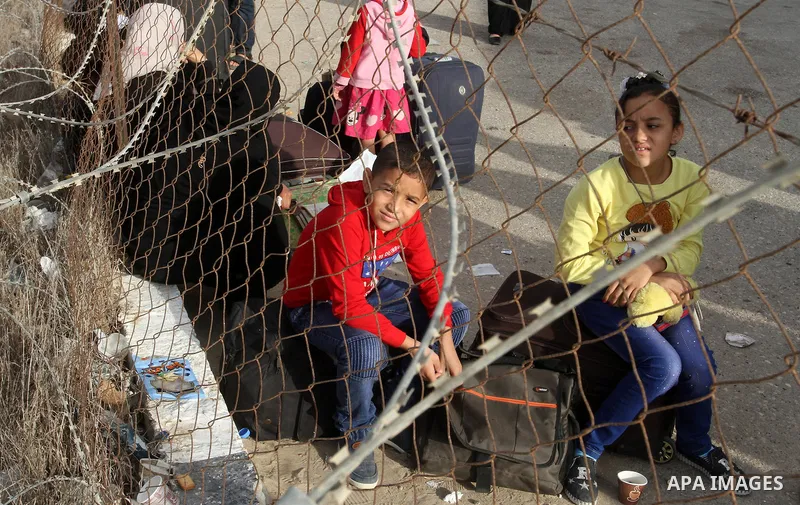 Palestinians wait for travel permits to cross into Egypt through the Rafah border crossing after it was opened by Egyptian authorities for humanitarian cases, in Rafah in the southern Gaza Strip October 19, 2016. Photo b...